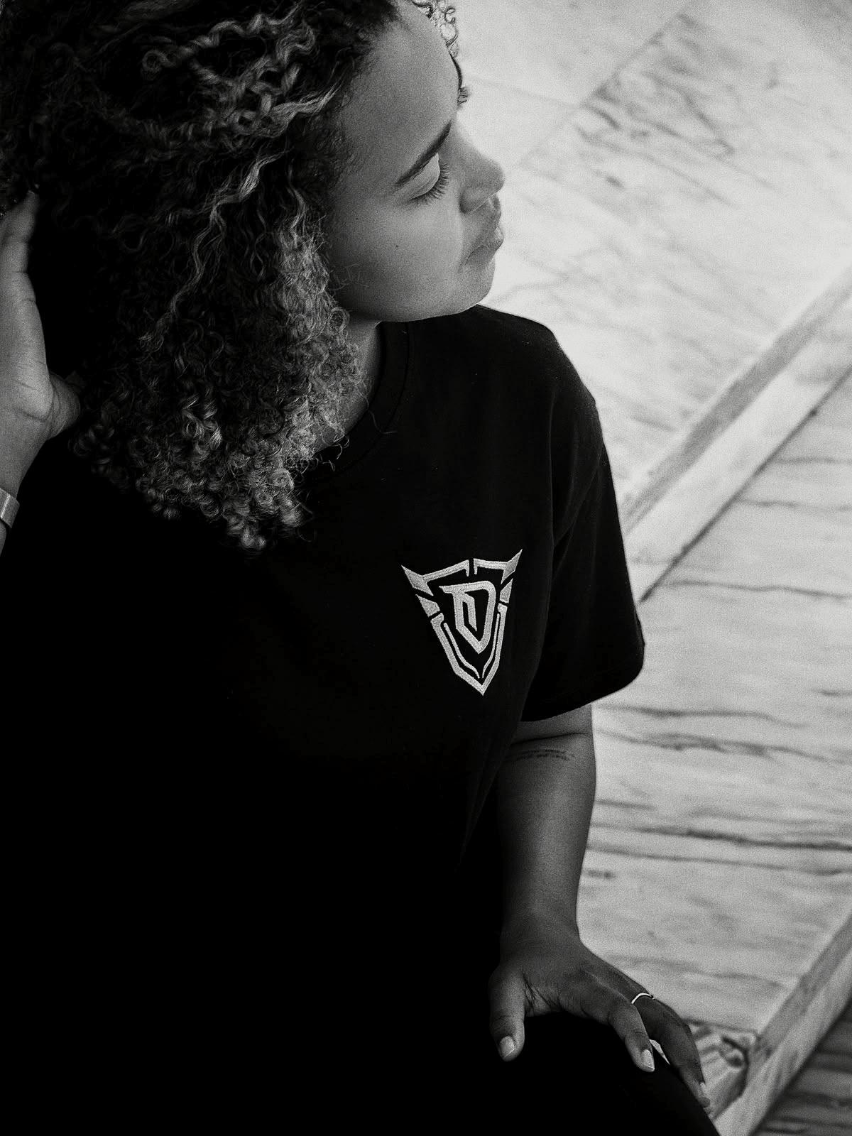 In profile, against a marble wall.