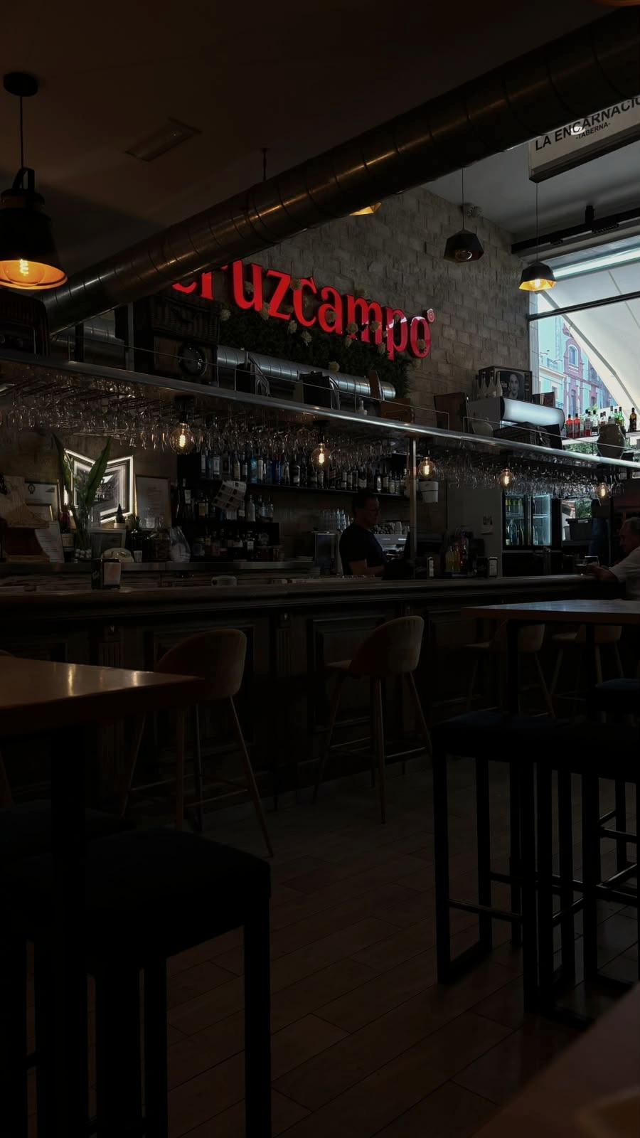The inside of a bar, late afternoon.